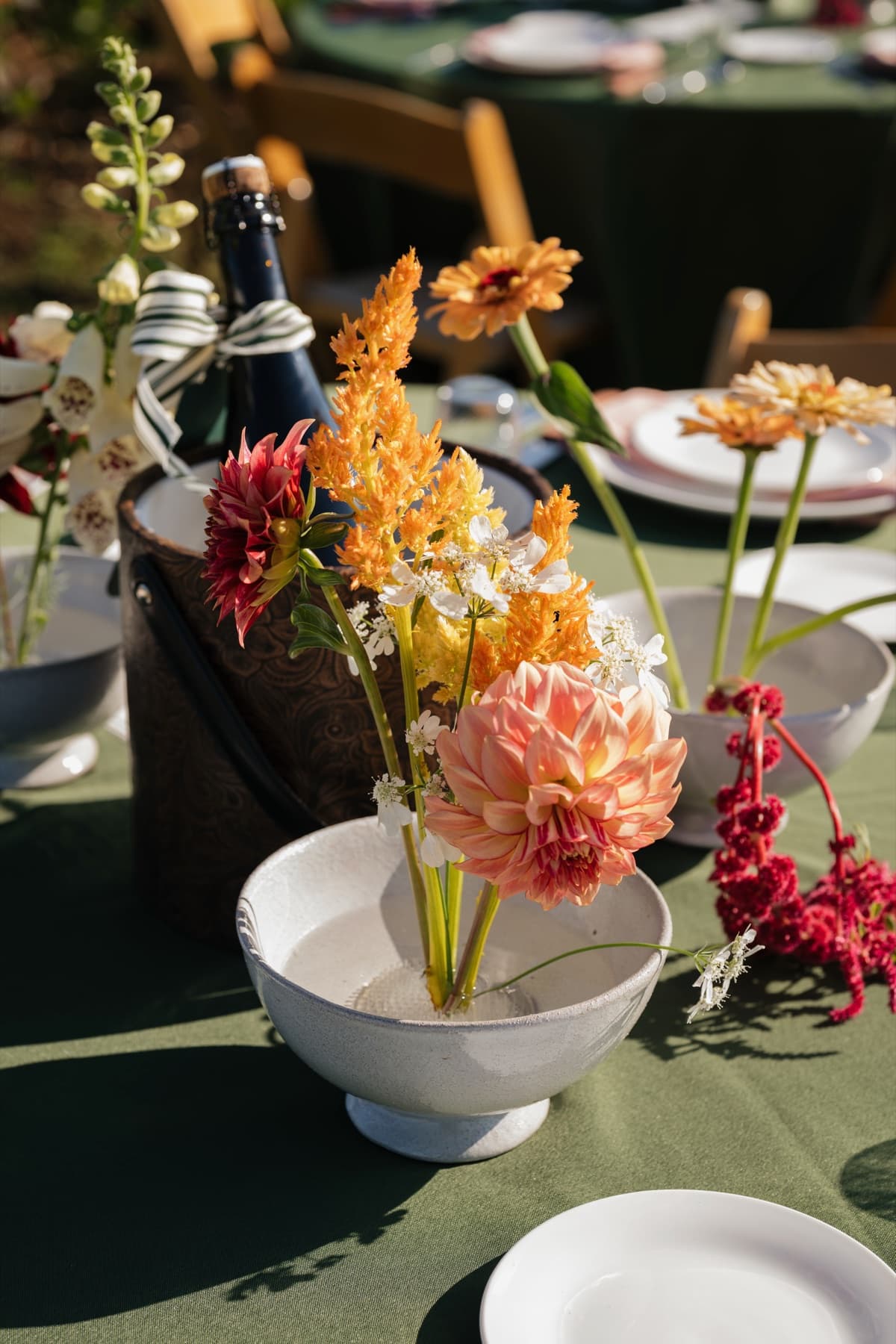 Vintage ice bucket styled with florals on a reception table